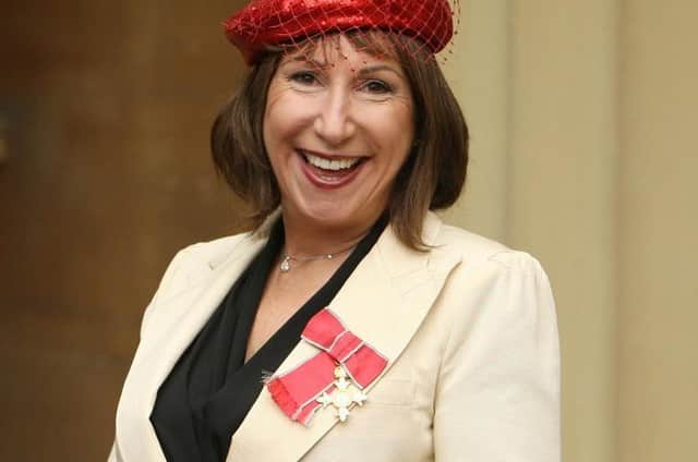 Kay Mellor wears her OBE at Buckingham Palace.
