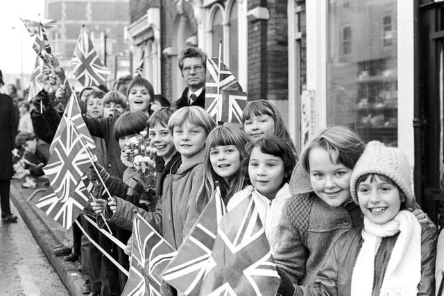 Excited school children line the streets of Wakefield for the Queen's visit.