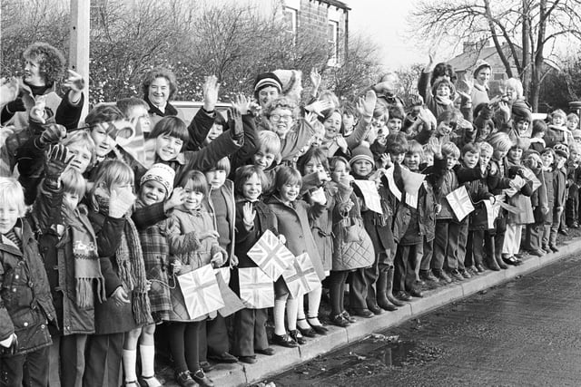 The streets of Wakefield are lined with waving school children.
