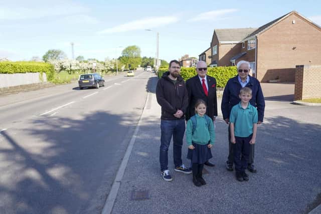 Councillors and children on the road which they say needs speed restrictions.