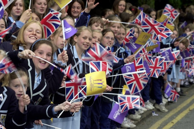 Wakefield Girls High School pupils wave on the runners of the Queen's jubilee baton relay, 2002.