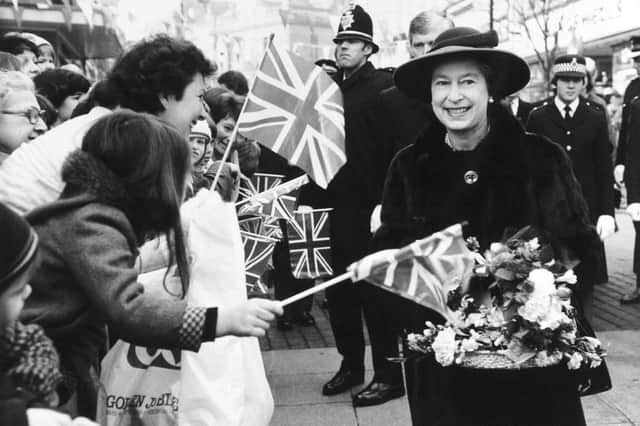 Enthusiastic crowds lean forward to greet the Queen during her visit to the Wakefield pedestrian precinct, 1982.