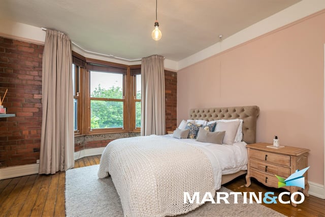 One of four bedrooms, this room has an open brickwork feature wall, with natural light flooding in through its large bay window.