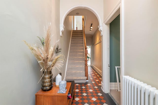 The hallway with period archway features, and a staircase leading up to the first floor.