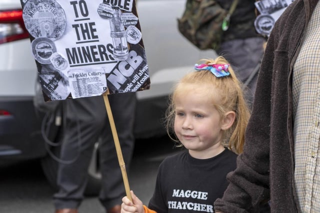 A young marcher with a placard commemorating the miners' strike of 1984-85