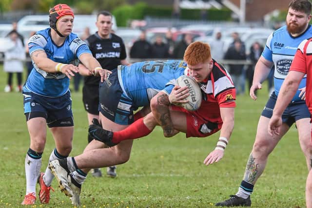 Fryston Warriors' Louie Tomlinson is stopped in his tracks by Featherstone Lions player Jake Roberts in the Castleford Cup semi-final. Picture: Jonathan Buck
