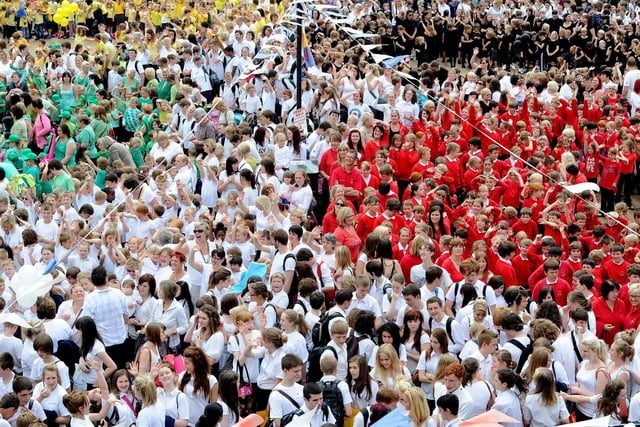 Over 3,000 people, mostly children form local schools, gathered in the middle of Ossett, to recreate a large image of the Olympic Flag formation as well as trying to break a world record.