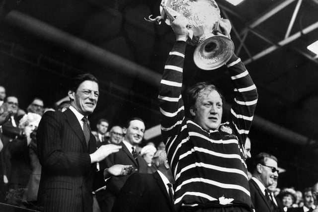 Angus Ogilvy, the husband of Princess Alexandra, watching as the captain of Featherstone Rovers celebrates winning the Challenge Cup at Wembley.