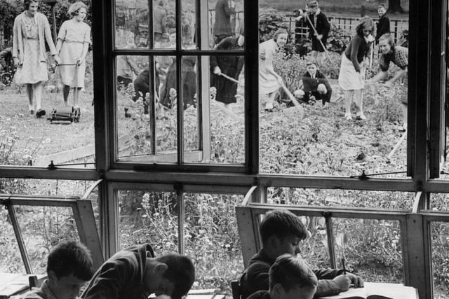 Some pupils at South Featherstone Modern School, Purston, have their heads down over their desks while others are busy in one of the largest school gardens in England.