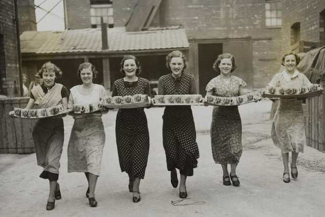 A Castleford firm are now engaged on orders received for over a quarter of a million coronation mugs, beakers, jugs and ashtrays. - Girls taking trays of the finished mugs to the dispatch department of a Castleford Pottery firm, Castleford, Yorks.