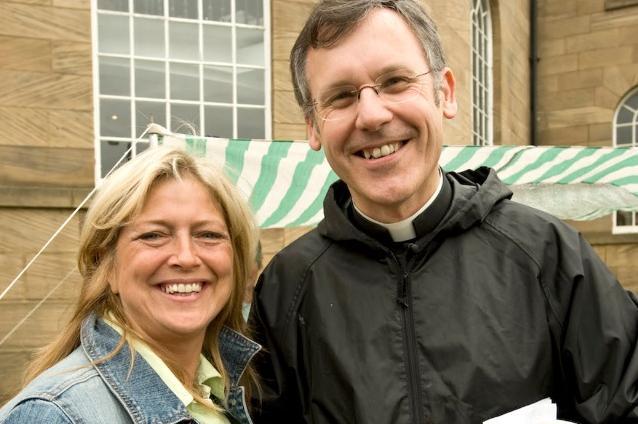 Father Brian Bell with congregation member Vicky Lewis outside the parish church.