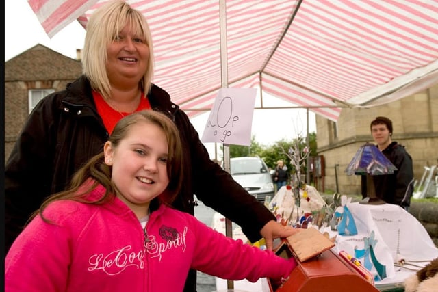 Joanne Squire watches over the tombola box as Bethany Townend reaches in.