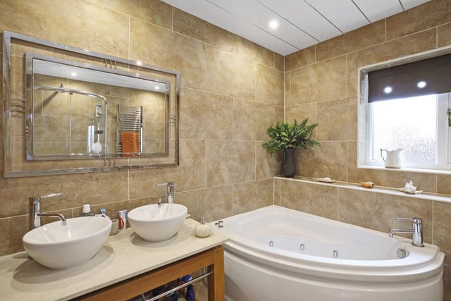 Twin wash basins and a spa bath in this stylish and modern bathroom.
