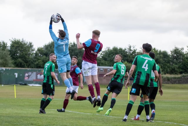The Golcar goalkeeper makes a clean catch as he is challenged by George Doyle. Picture: Mark Parsons