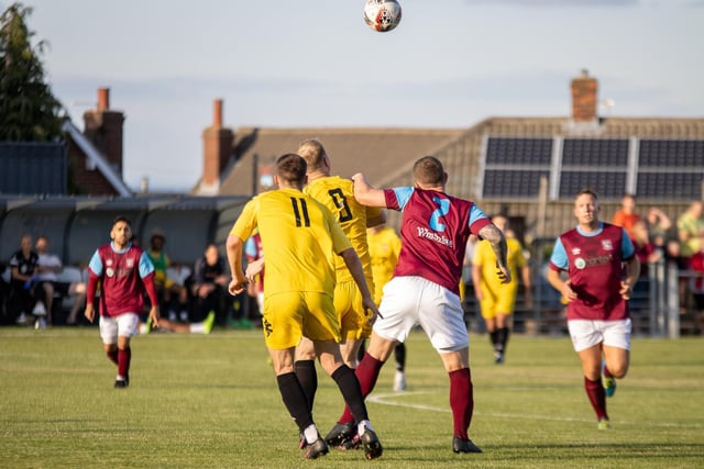 An aerial challenge faces Emley and Liversedge players. Picture: Mark Parsons
