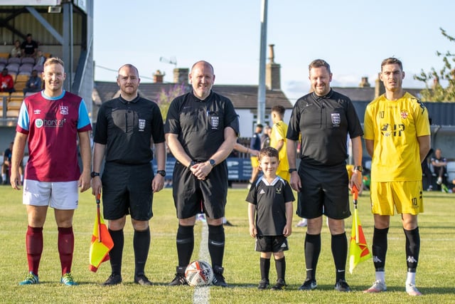 Emley captain Tom Claisse and Liversedge skipper Ben Atkinson line up before the game with the match officials and the match mascot. Picture: Mark Parsons