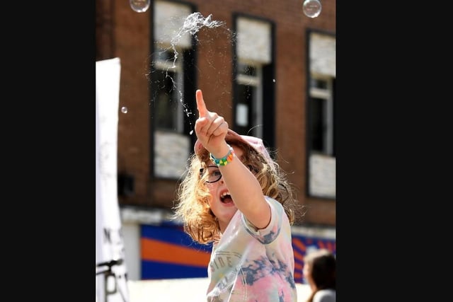 Children play with bubbles at the festival.