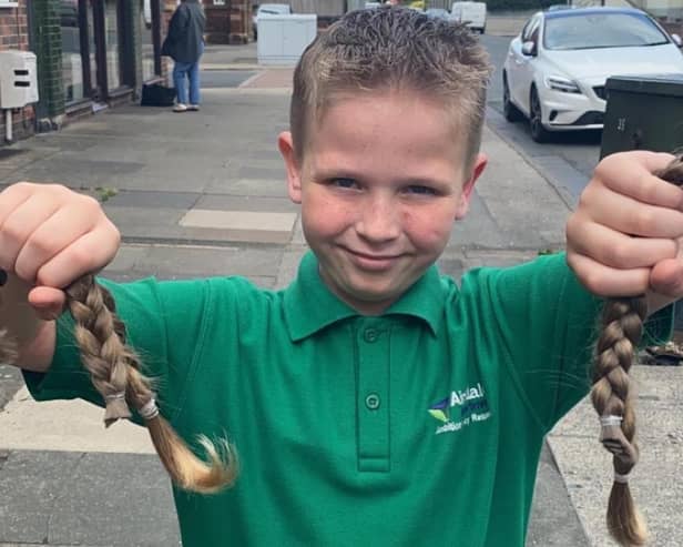Eight-year-old Bobby Brooks with the hair he is donating to the Little Princess Trust