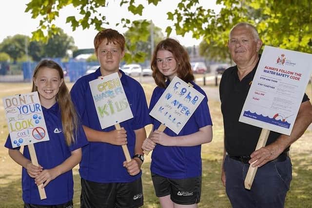 Pupils from De Lacey Academy in Knottingley have designed posters warning the dangers of open water swimming. L-R Erin Norton, Thomas Clarke and Ellie Geen with Tim Moran. Picture Scott Merrylees