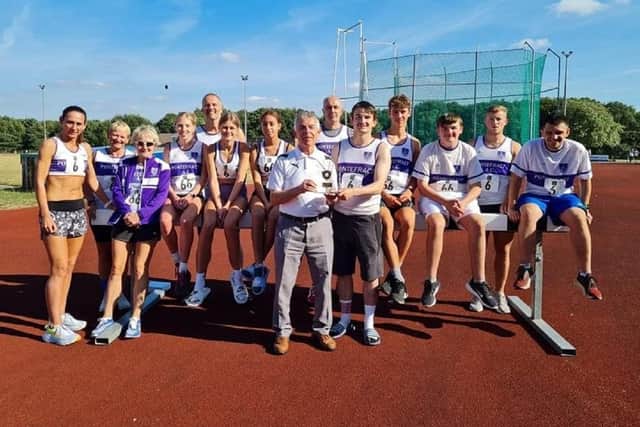 Pontefract Athletics Club's athletes pictured with club chairman Cyril Jones and the Northern Track and Field League Division Two winners trophy.