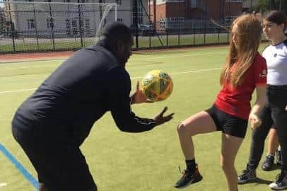 Ex-pro footballer Bruce Dyer helps pupils brush up on their football skills
