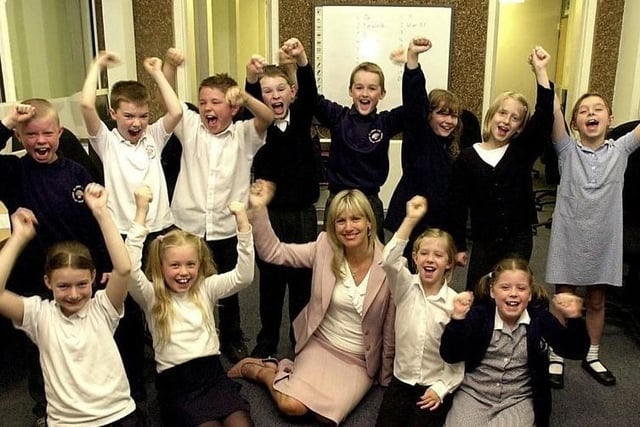 Celebrating their Good Ofsted report in 2005, for St.James J&I, Crigglestone Headteacher Colleen Gibson had her photo taken with Class 6, Year 4 pupils.