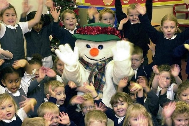 Snowman (aka Reception teacher Mrs Donna Clark) with pupils from the Reception Class and Nursery.