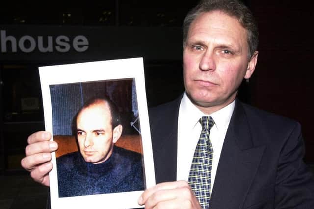 Former Detective Chief Superintendent Paul Johnston, pictured in 2000, outside Leeds Crown Court holding an image of Christopher Farrow after the killer was given a life sentence for the murder of Wendy Speakes.
