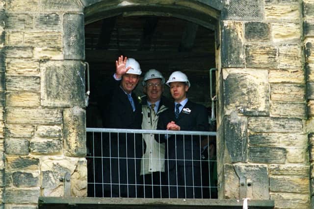 King Charles waves from the top floor of the Navigation Warehouse as he toured the Wakefield Waterfront Regeneration Project in 1999.