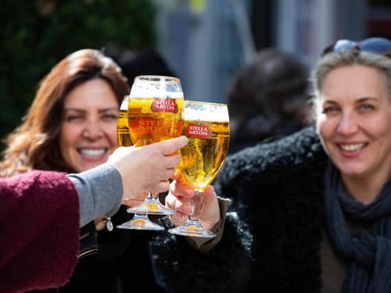 Friends enjoy a pint of Stella Artois amid the return of customers to the hospitality sector, following the latest lifting of restrictions. Photo: PA