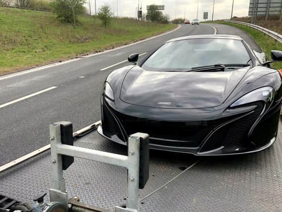 The owner of a McLaren supercar saw their motor towed away by cops after it was driven off the forecourt without a number plate or insurance.