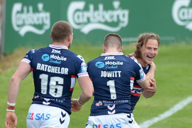 Wakefield Trinity's Jacob Miller celebrates his try with James Batchelor and Max Jowitt (DEAN WILLIAMS)