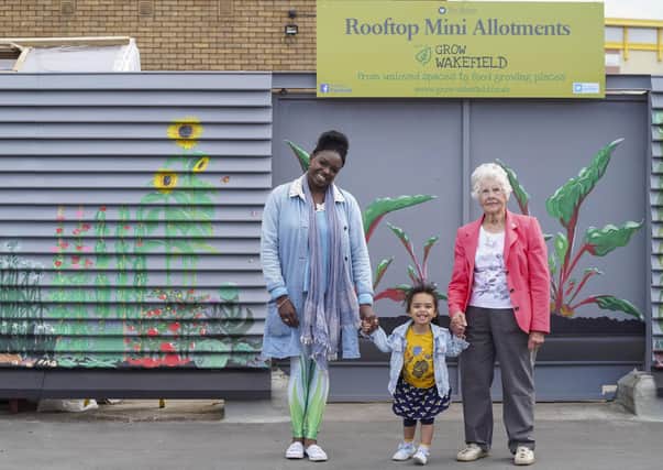 Grow Wakefield's oldest member Ann Tomlinson and youngest member Rose Timmerman with artist Hoshi Dee at the unveiling of a new mural at The Ridings Rooftop Mini Allotments. Picture Scott Merrylees