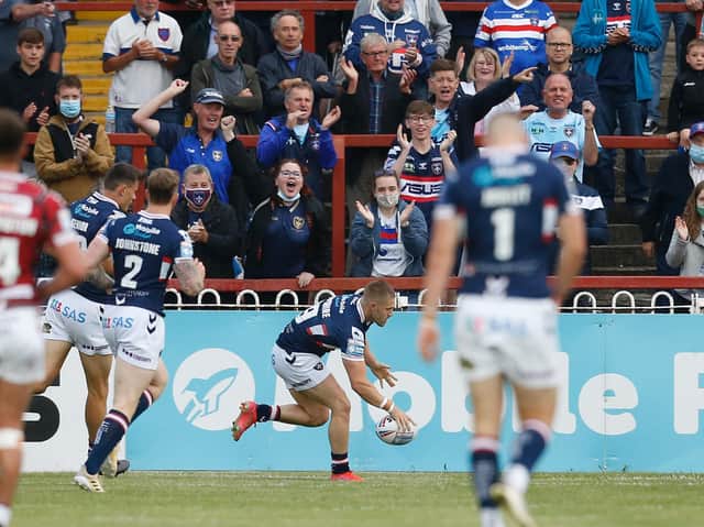 Picture by Ed Sykes/SWpix.com - 24/06/2021 - Rugby League - Betfred Super League Round 11 - Wakefield Trinity v Wigan Warriors - The Mobile Rocket Stadium, Wakefield, England - Wakefield Trinity fans celebrate as Ryan Hampshire scores their first try