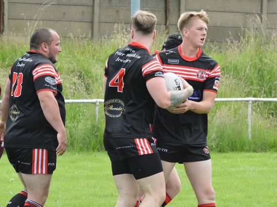 David Barker is congratulated on his try for Normanton Knights against Dewsbury Moor Maroons. Picture: Rob Hare