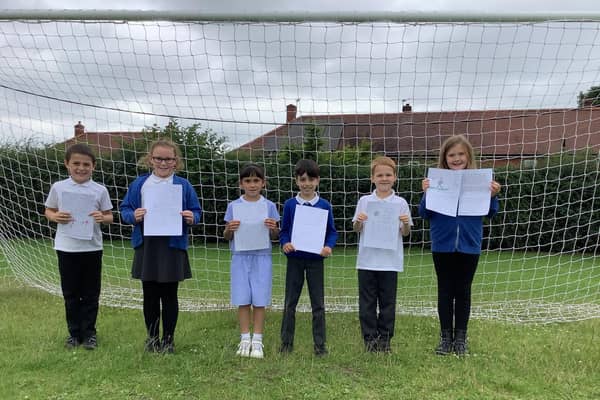 Pupils from Ossett South Parade Primary School show off their letters of support for the England football team. Photo: Ossett South Parade Primary School
