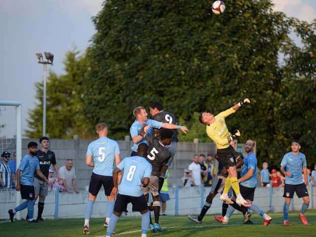 Action form Ossett United's pre-season clash with Sheffield Wednesday U23s. James Walshaw challenges. Pic: Jon Hunt Photography