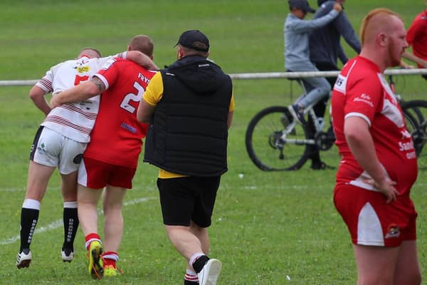 Rugby League at its finest as Fryston Warriors A player Adam Kerry helps to carry off injured Eastmoor Dragons A player Caine McVittie in the sides' Yorkshire Men's League game. Picture: Ken Czmeiduch