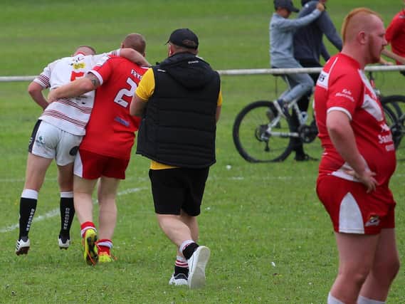 Rugby League at its finest as Fryston Warriors A player Adam Kerry helps to carry off injured Eastmoor Dragons A player Caine McVittie in the sides' Yorkshire Men's League game. Picture: Ken Czmeiduch