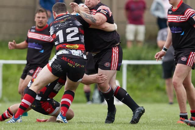 Normanton Knights' Stuart Biscomb is stopped in his tracks by determined Eastmoor Dragons tacklers. Picture: John Clifton