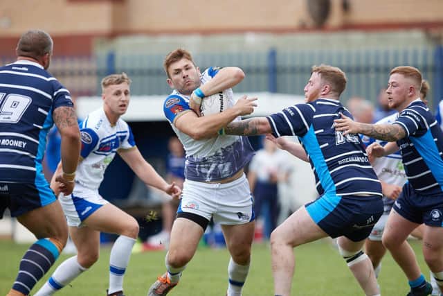 Lock Lane's Craig Savage up against three Featherstone Lions defenders. Picture: John Clifton