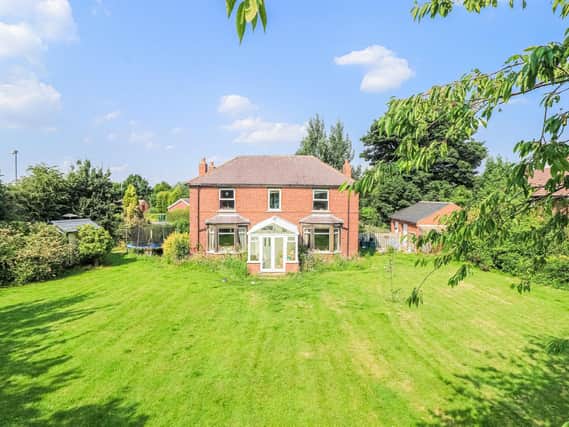 An expanse of lawned garden with this South Hiendley home