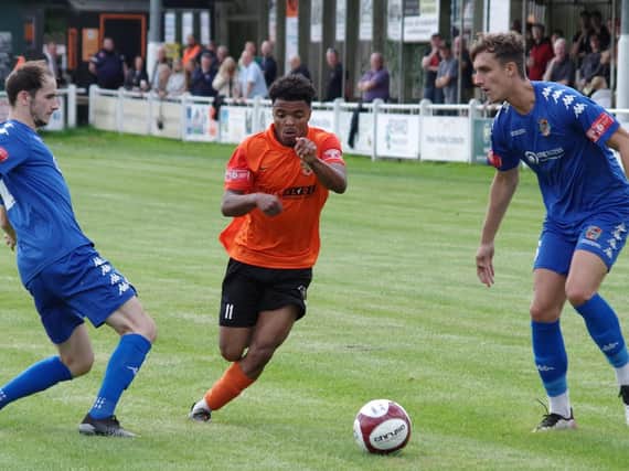 Brighouse Town's Javelle Clarke takes on Pontefract Collieries defenders Jack Greenough and Spencer Clarke. Picture: Steve Ambler