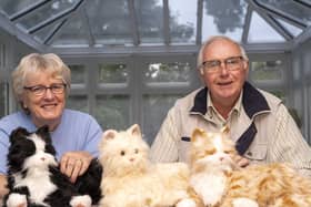 Sheila Wainwright and Peter Clarke  -president of Wakefield Rotary with the robotic cats. Picture Scott Merrylees