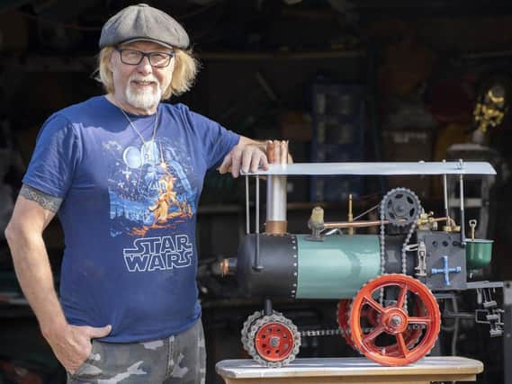 Colin Goodall with the steam engine he built from junk.