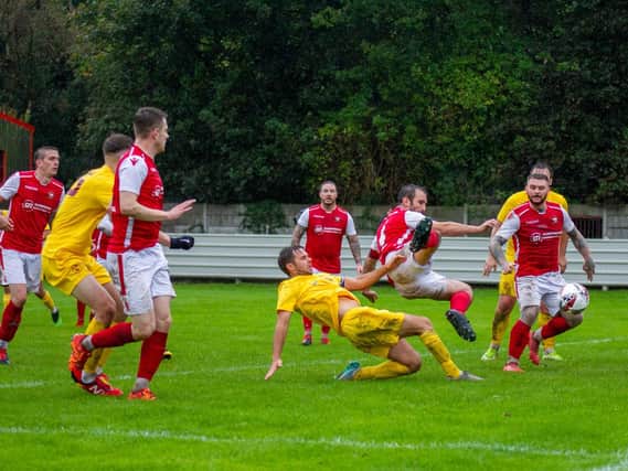 Emley's Jamie Price stretches to get an effort in against Thackley. Picture: Mark Parsons