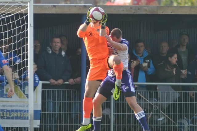 Pontefract Collieries goalkeeper Ryan Musselwhite claims the ball during his man of the match display against Halifax Town.