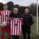 Fryston AFC are presented with their new shirts by sponsors Marie and David, from  Castle Commercial Cleaning Services.