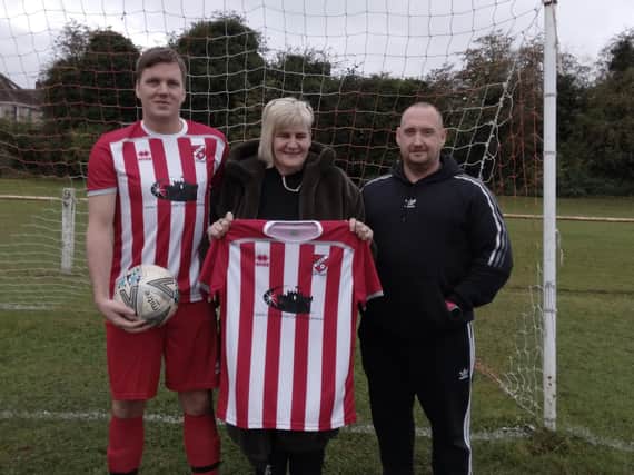 Fryston AFC are presented with their new shirts by sponsors Marie and David, from  Castle Commercial Cleaning Services.