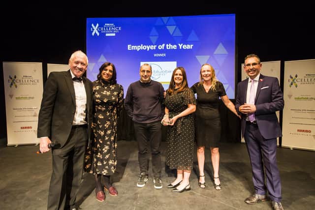 Wakefield Express Business Excellence Awards 2021. Employer of the Year Award. From the left, Host Harry Gration with Narinder Gill, Jas Gill, Jess Gaskell and Rose Smith from winner Bluebird Care Wakefield and Kirklees, and Darren Byford from Wakefield First.